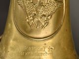a gold bell with a picture of a man on it