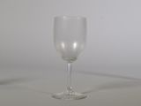 a wine glass sitting on a table with a white background