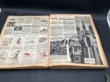 an old book that is open on a table