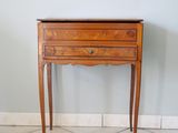 a small wooden table with a drawer on top of it