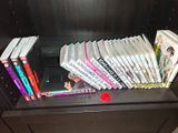 a lot of books that are on top of a book shelf