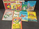 several children ' s comics are lined up on a black surface