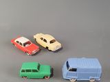 four toy cars that are sitting on a table