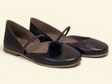 the shoes are brown and black with a pom pom on the toe