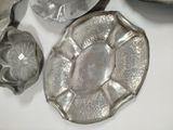 a silver plate with a flower design on it