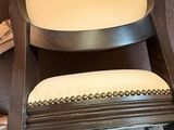 a wooden rocking chair with a white cushion on it