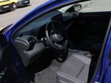 a blue car that is parked in a parking lot