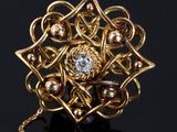 a close up of a gold and diamond ring on a black surface