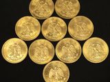 a bunch of gold coins sitting on top of a black surface