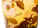 a glass vase with a yellow and brown floral design on it