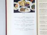 an open book with a picture of a plate of food on it