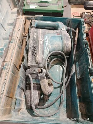 a box with a drill and other tools in it