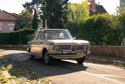 une voiture qui roule dans la rue devant une clôture