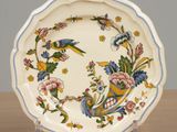 a plate with a bird and flowers design on it