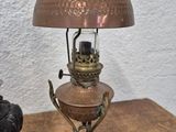 a lamp that is sitting on a table next to a statue