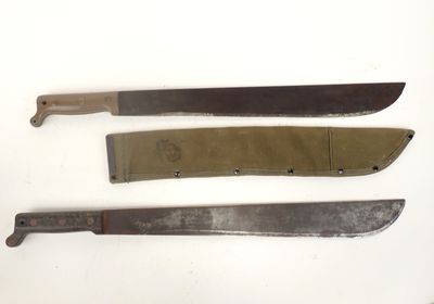 three knives are sitting on a white surface with a knife in the middle of them