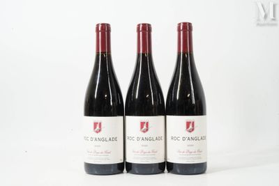 three bottles of red wine sitting next to each other on a table