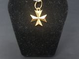an image of a small gold cross on a black display case