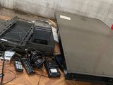 a table with a laptop, a cell phone, and other electronics on it