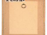 an old picture frame with a ring hanging from it ' s side