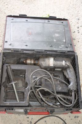 a tool in a case that is sitting on the ground