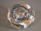 a glass bowl with a gold and white design on it