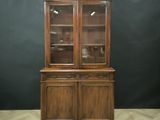 a wooden display cabinet with glass doors on top of it