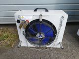a white air conditioner sitting on the side of the road