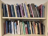 many books that are on the shelves in the room