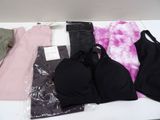 a lot of clothes that are sitting on a table