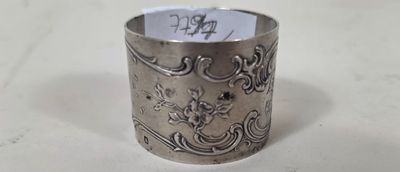 a silver ring on a table with a note in it