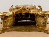 a gold clock that is sitting on a table