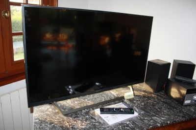 a flat screen tv sitting on top of a table