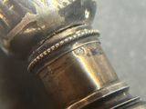 a close up of a silver object on a table