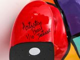 a red object with writing on it sitting on a table