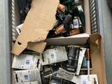 a box full of batteries on the floor next to a pair of shoes