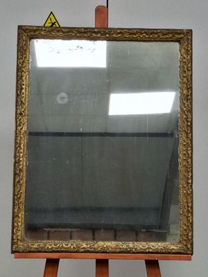 a wooden easel with a mirror on top of it