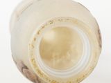 a close up of an empty bottle on a white surface