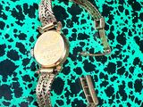 an image of a wrist watch on a green and black background