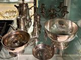 many silver objects on display in a glass case
