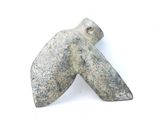 a stone object that looks like an arrow on a white surface