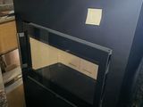 a black stove that is in a room with boxes