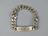 an image of a gold bracelet with a name engraved on it