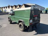 a green land rover parked in a parking lot