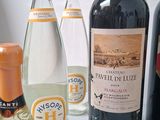 several bottles of wine are lined up on a table