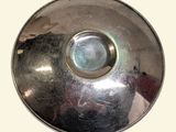 a shiny metal object with a hole in the middle