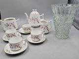 a lot of cups and saucers sitting on a table