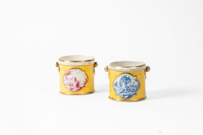 pair of yellow vases with blue and pink flowers on them