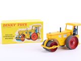 yellow and red toy tractor and box of dinky toys