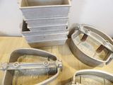 several pieces of metal are sitting on a wooden table